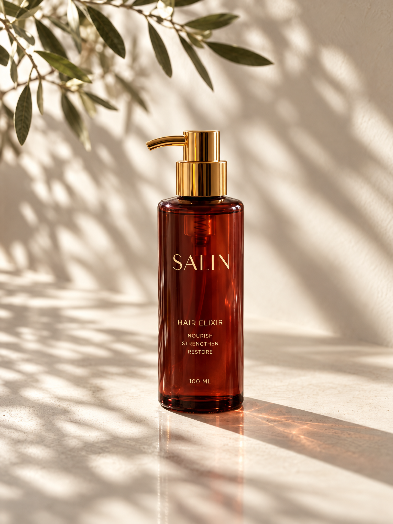 Amber SALIN Hair Elixir bottle with a gold pump photographed on a sunlit surface.