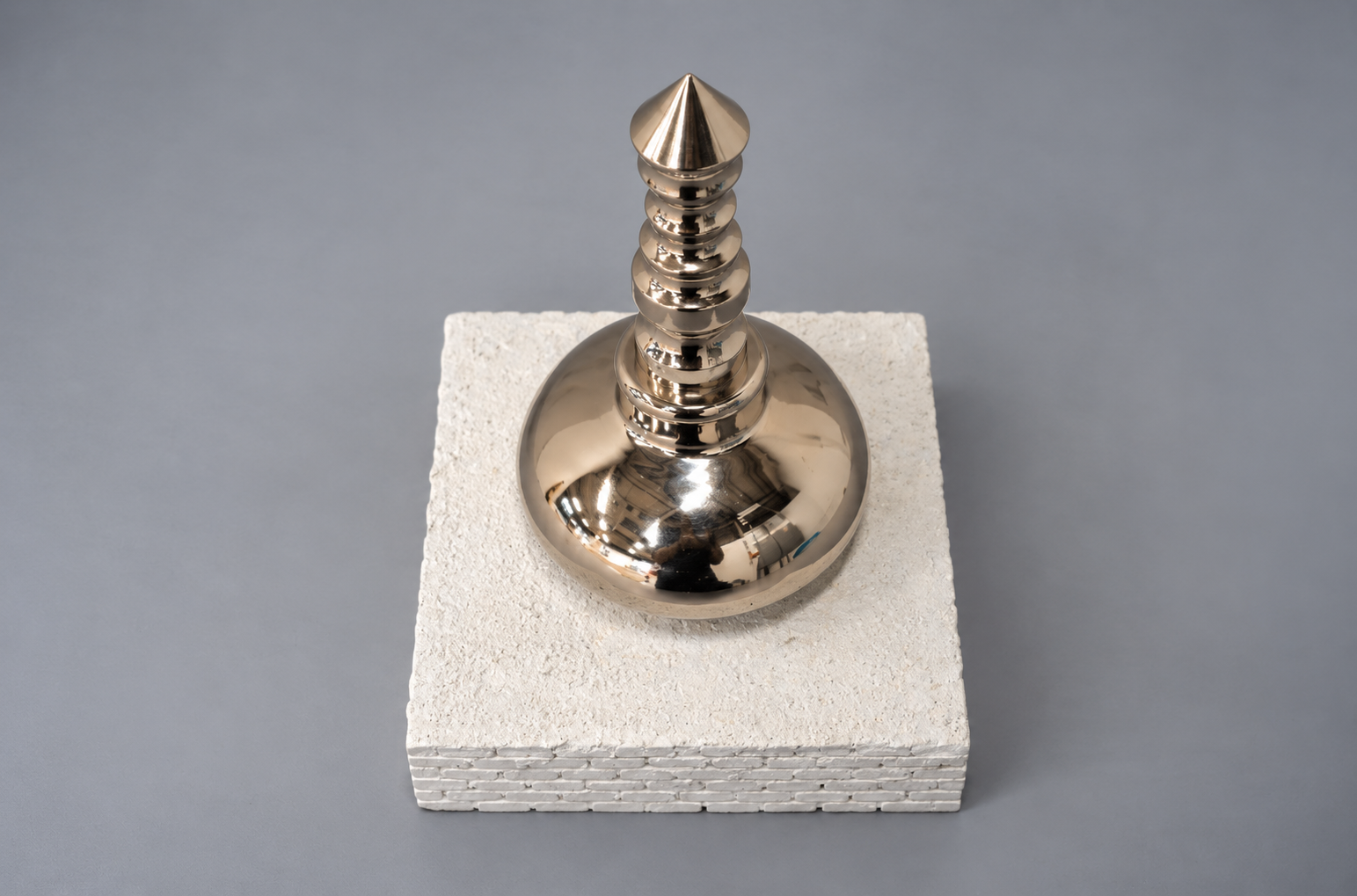 Reflective Metal Finial on Textured Plinth.png