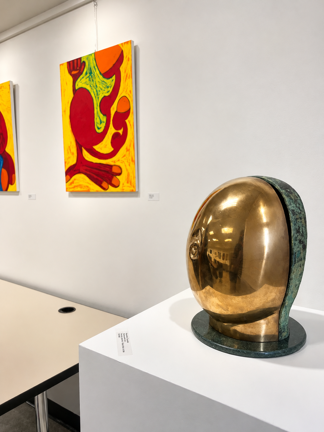 Reflective Bronze Sculpture in Modern Gallery.png