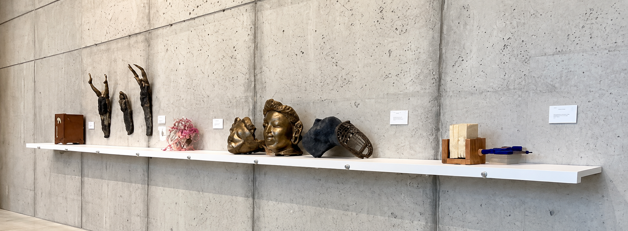 Sculptural Stories on a Concrete Wall.png