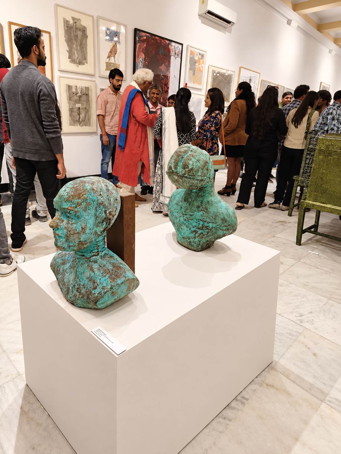 Verdigris Busts at a Lively Gallery Exhibition.png