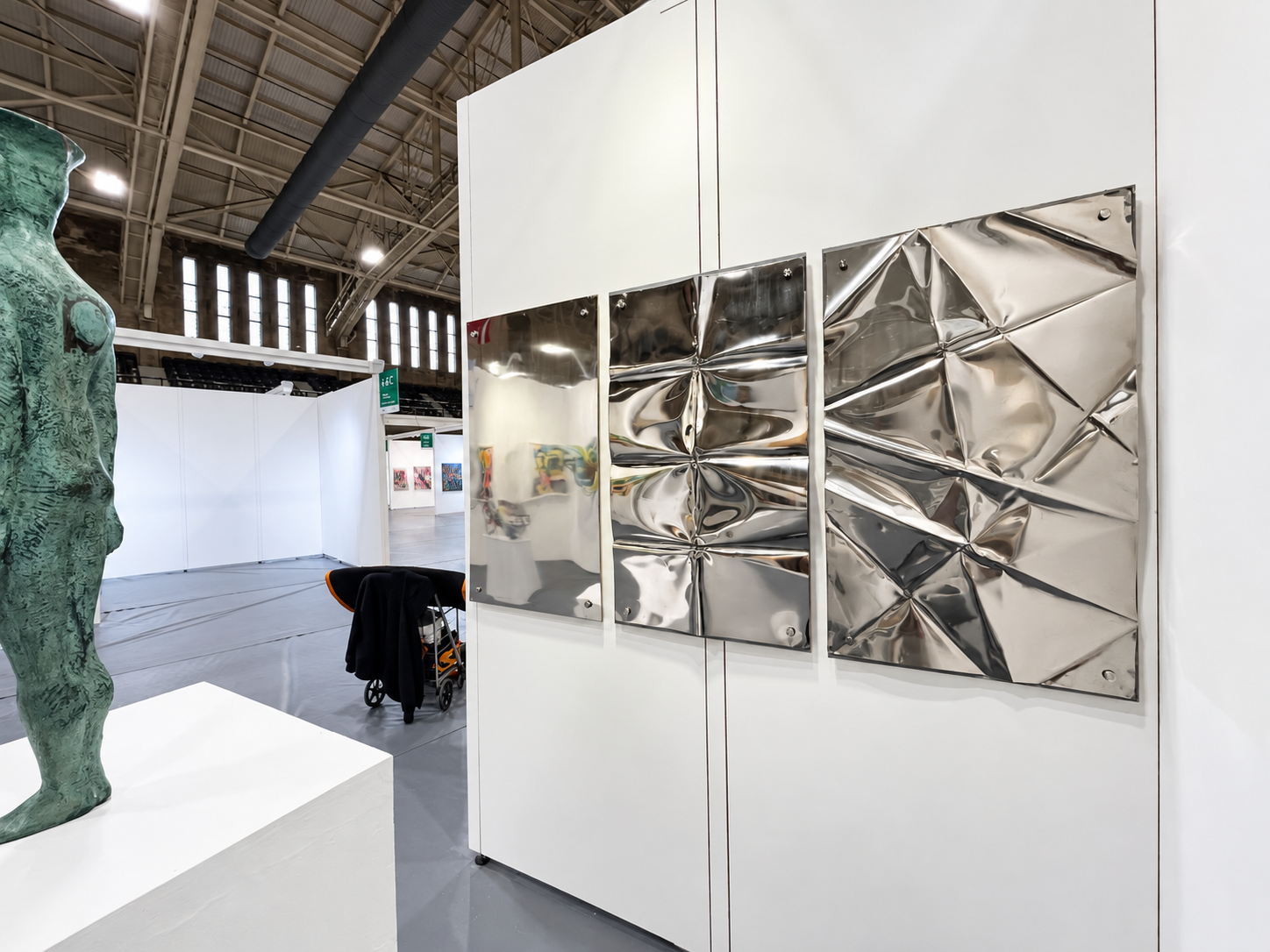 Reflective Metal Art at a Modern Fair.png