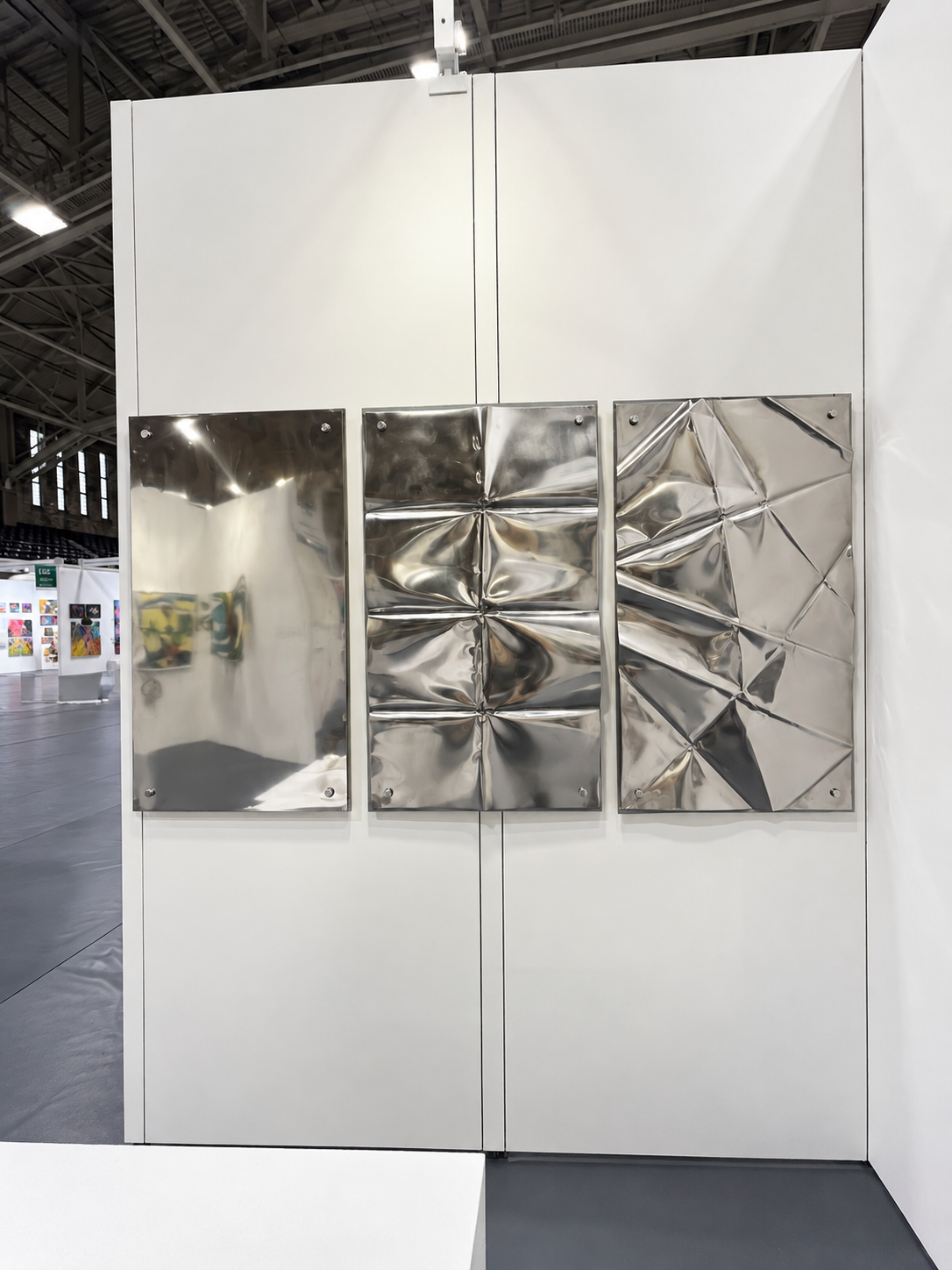 Reflective Metal Triptych in a Modern Gallery.png