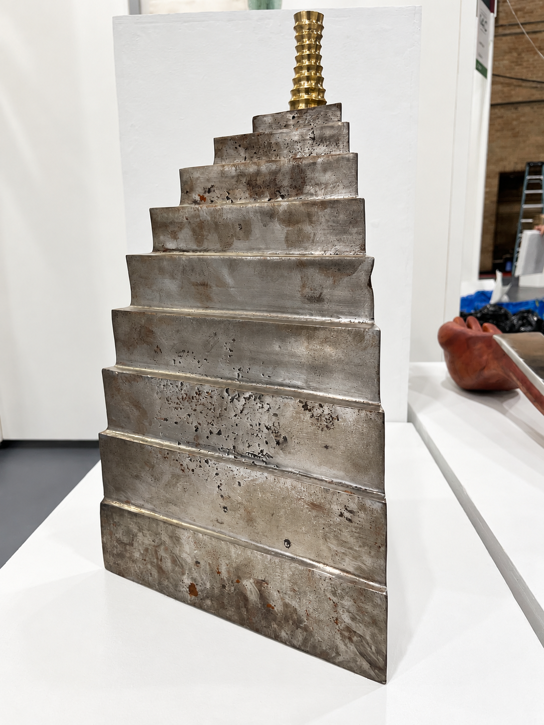 Weathered Stepped Metal Sculpture with Brass Accent.png