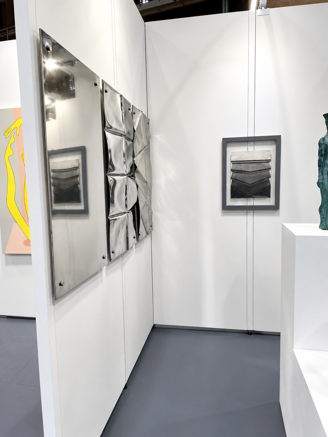 Reflective Metal Art in a Modern Gallery.png