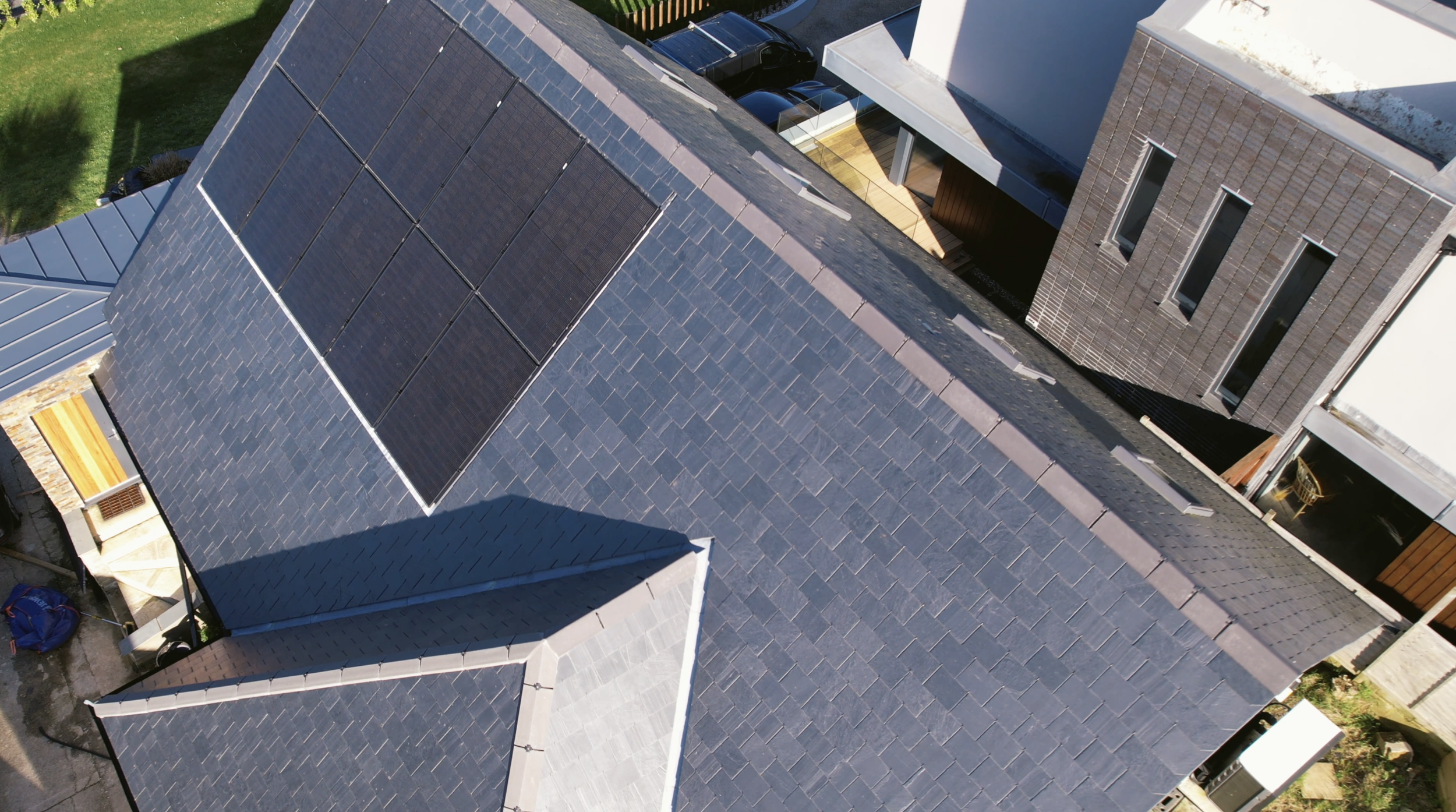 Aerial view of a house roof with solar panels.