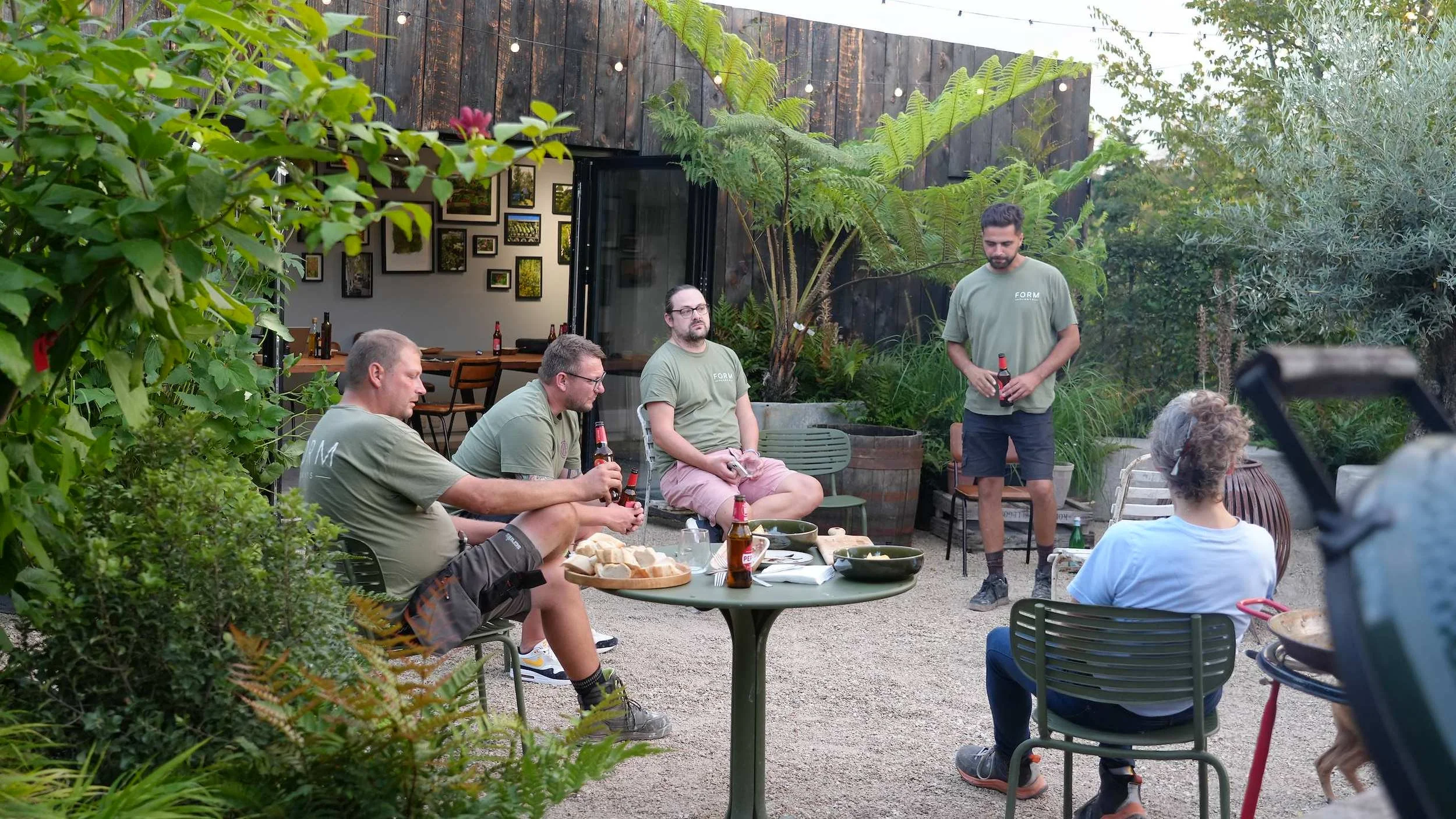 Guests gathered around the fire on the terrace at the Form Plants Row Town showroom