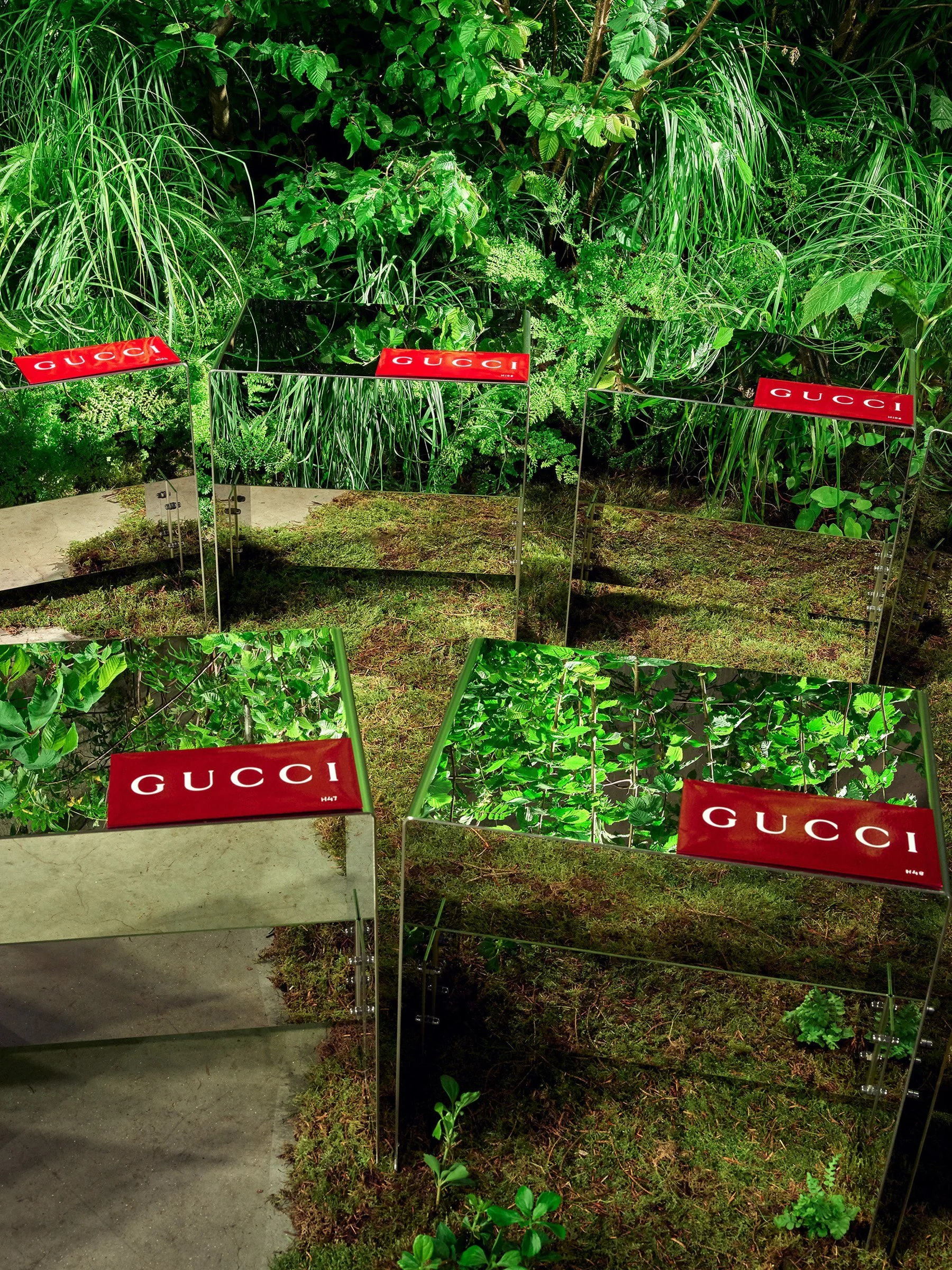 Mirrored Gucci display plinths set among ferns, grasses and moss in a Form Plants brand installation