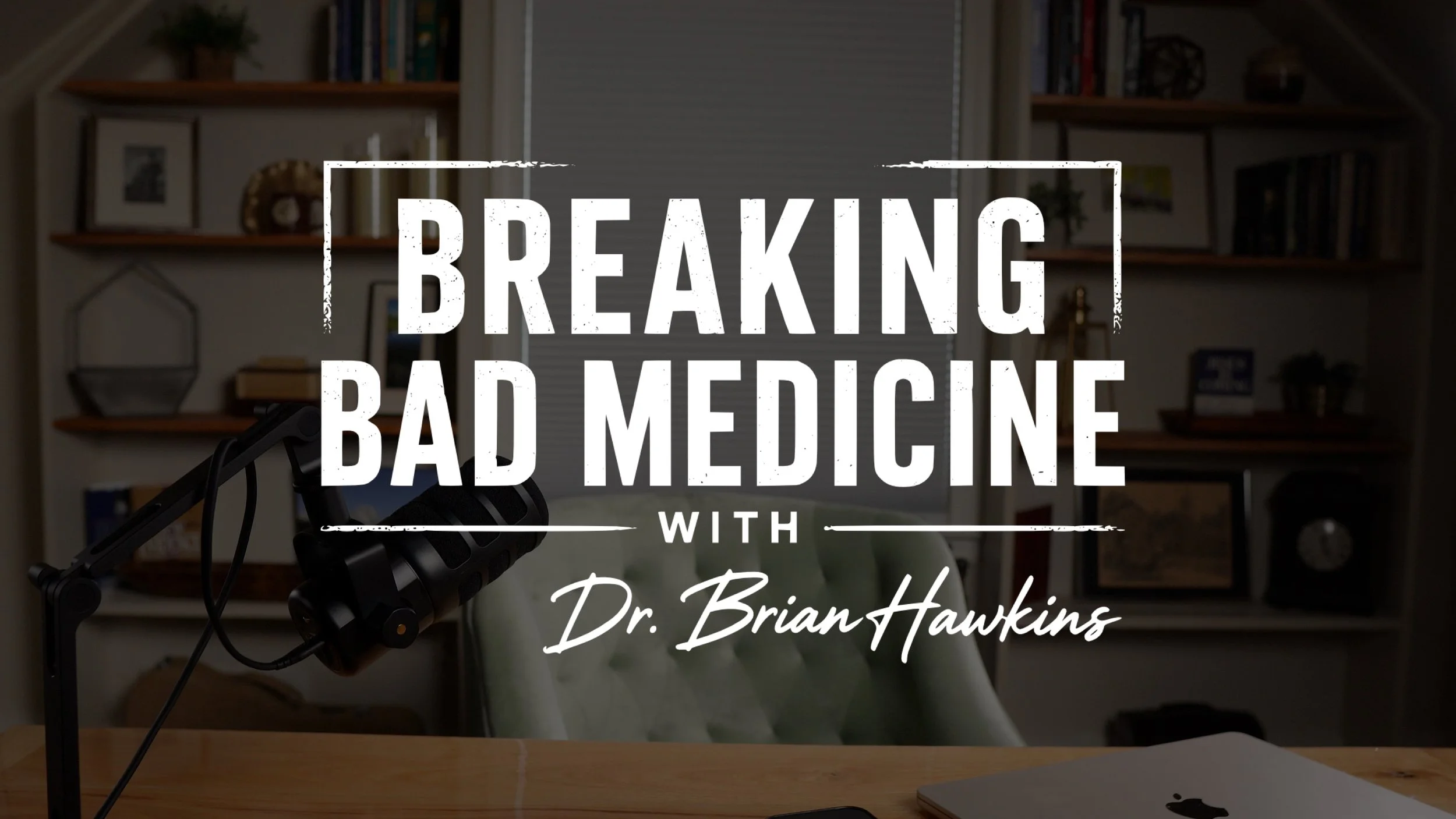 Streaming setup with a microphone on a boom arm, a closed laptop, a bookshelf in the background, and text overlay reading 'Breaking Bad Medicine with Dr. Brian Hawkins'.