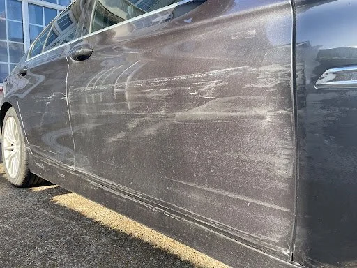 Dirt or mud on the side of a gray car.