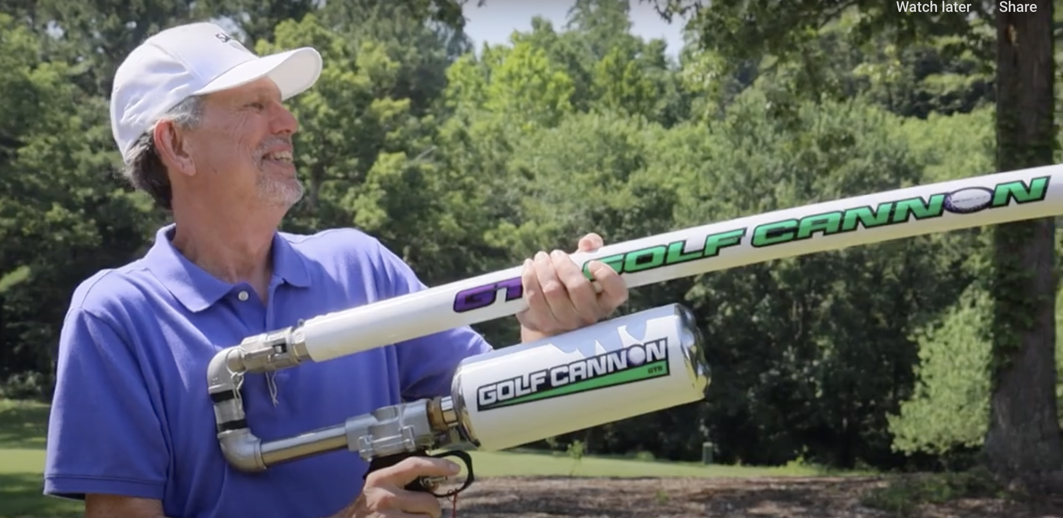 Man holding a Golf Cannon golf ball launcher outdoors on a golf course