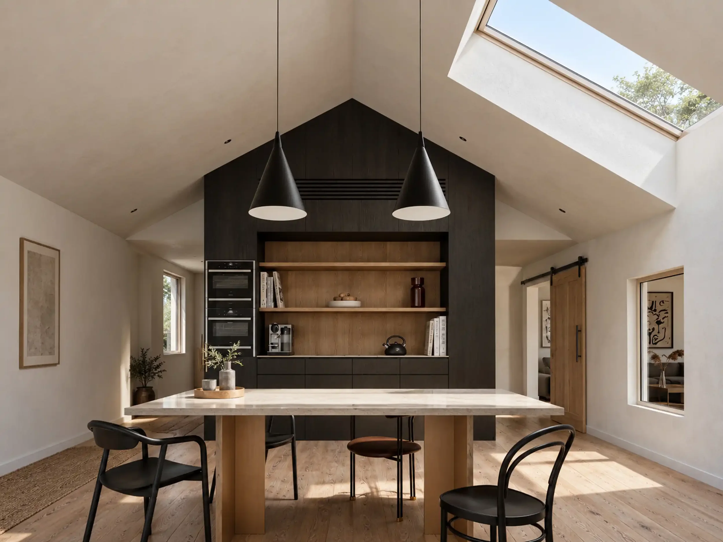 Modern kitchen with a marble dining table, black chairs, and a ceiling skylight. Two black pendant lights hang above the table, with built-in ceiling lights and a dark wood accent wall with open shelves behind. There are windows and artwork on the wa