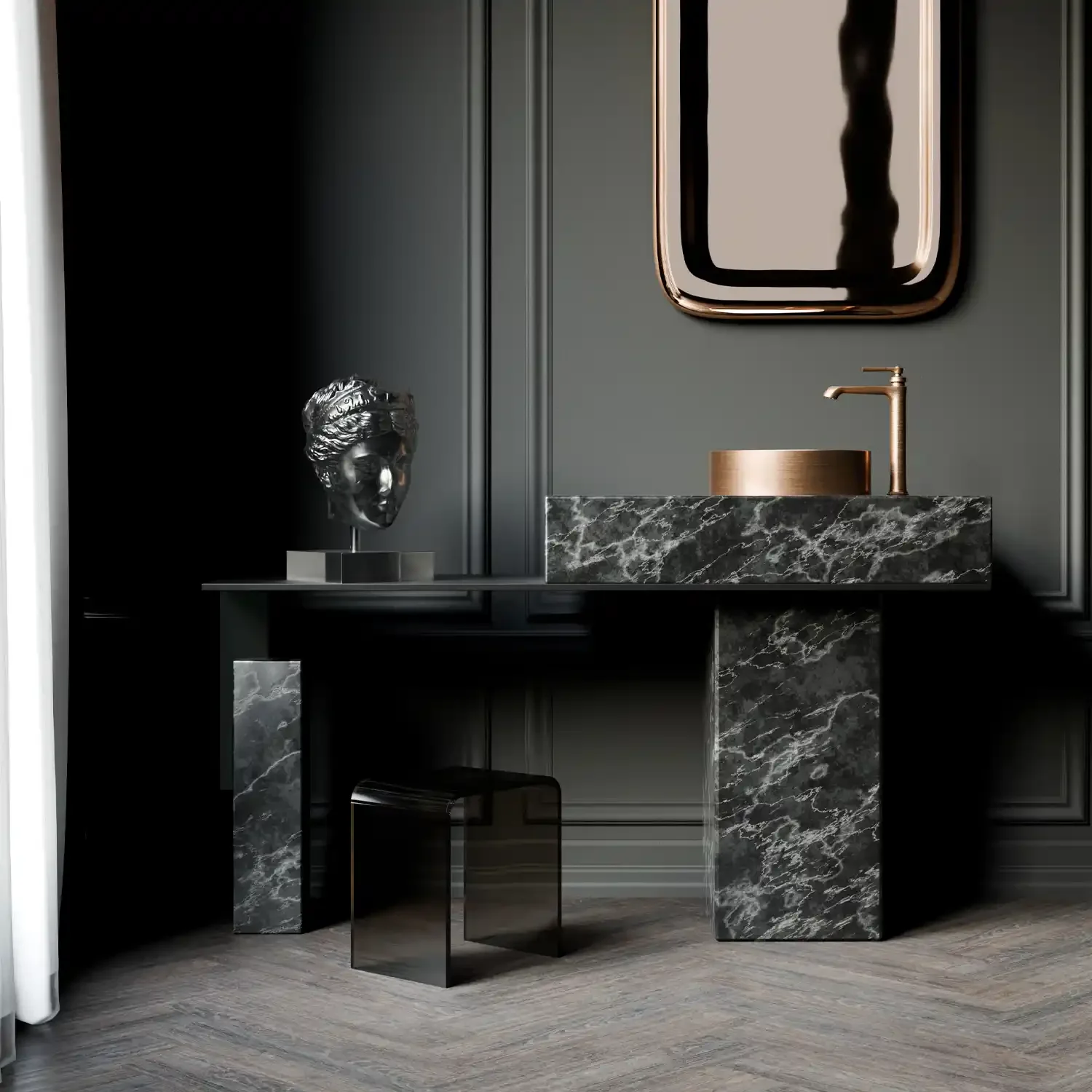Modern bathroom vanity with a black marble countertop, a gold faucet, and a gold vessel sink. A silver bust sculpture is placed on a matching black and silver side table. A geometric mirror hangs on a dark wall above the vanity.