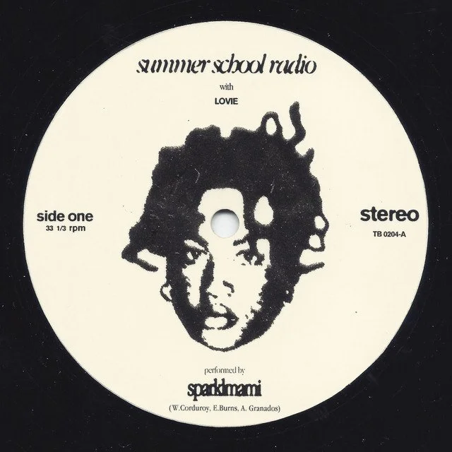 Close-up of a black vinyl record label with white background featuring the title 'Summer School Radio' with Love, artist name 'Sparkmani', and a monochrome illustration of a person's face with dreadlocks.