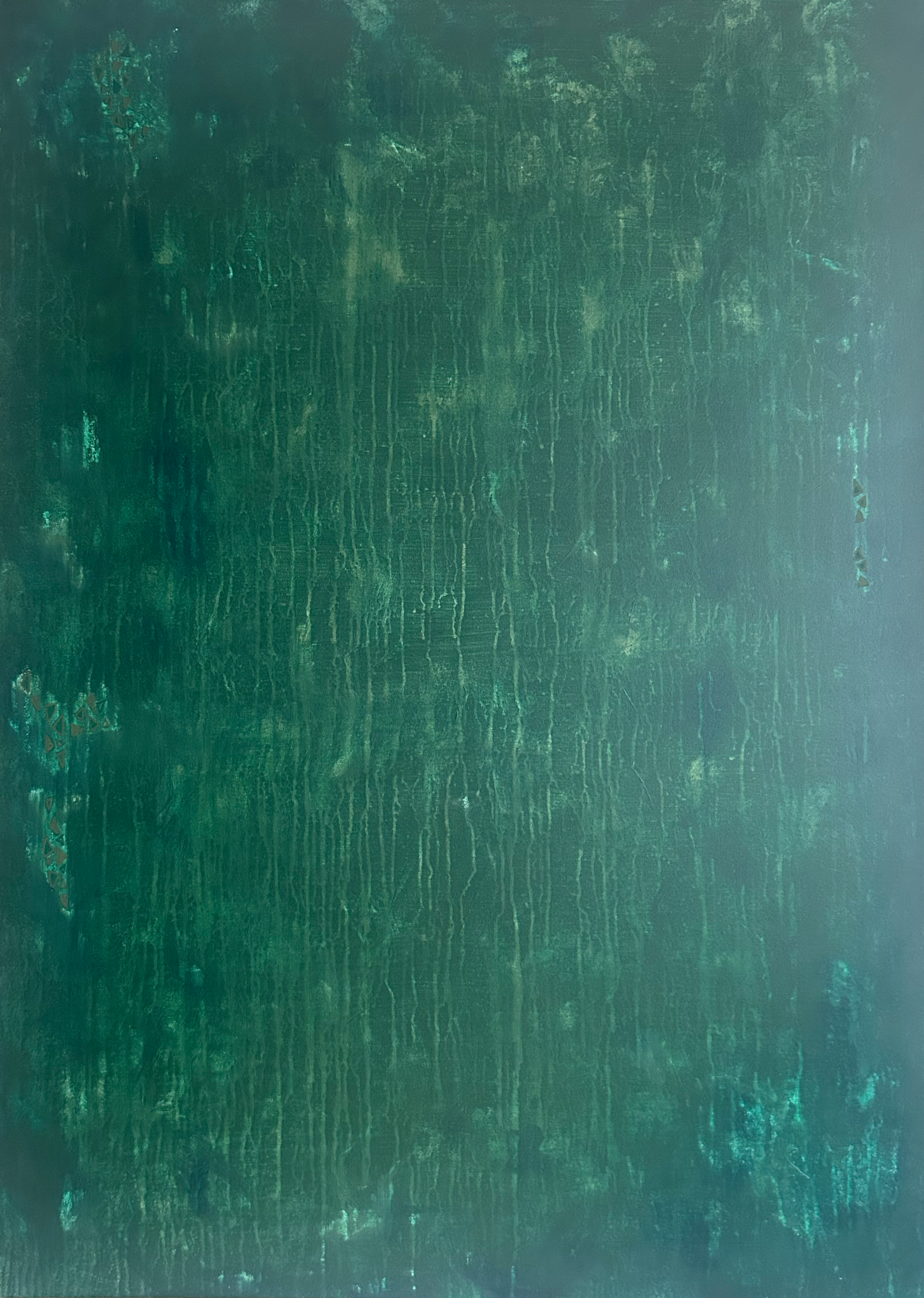 A green textured wooden surface with visible grain and some scratches, signs of wear and peeling paint.