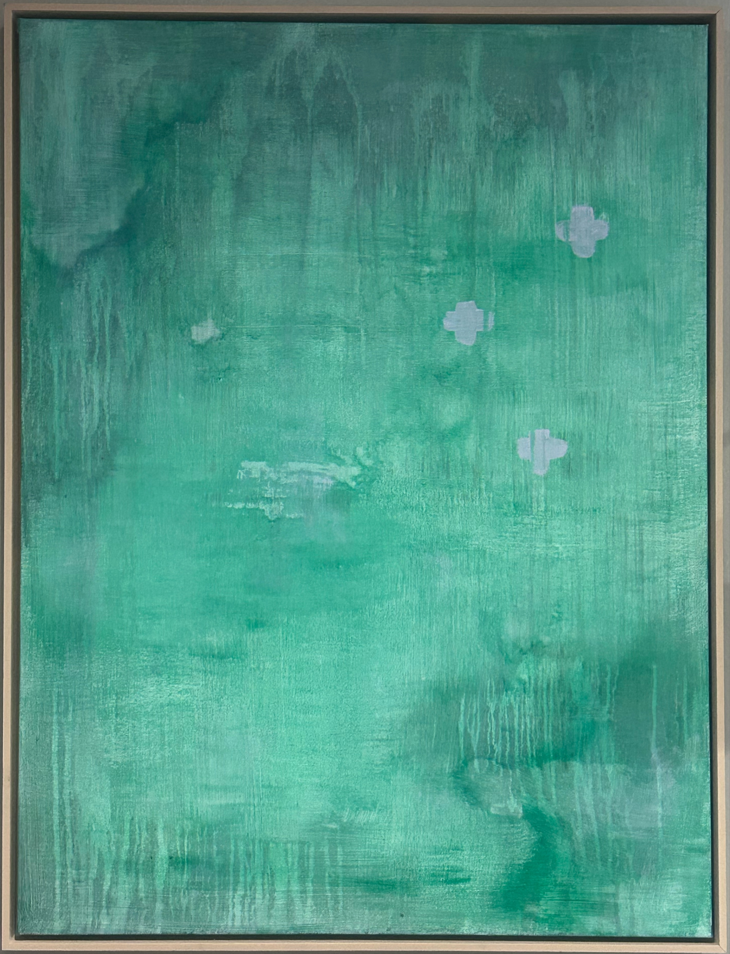 Green framed painting with white abstract shapes scattered across the canvas.