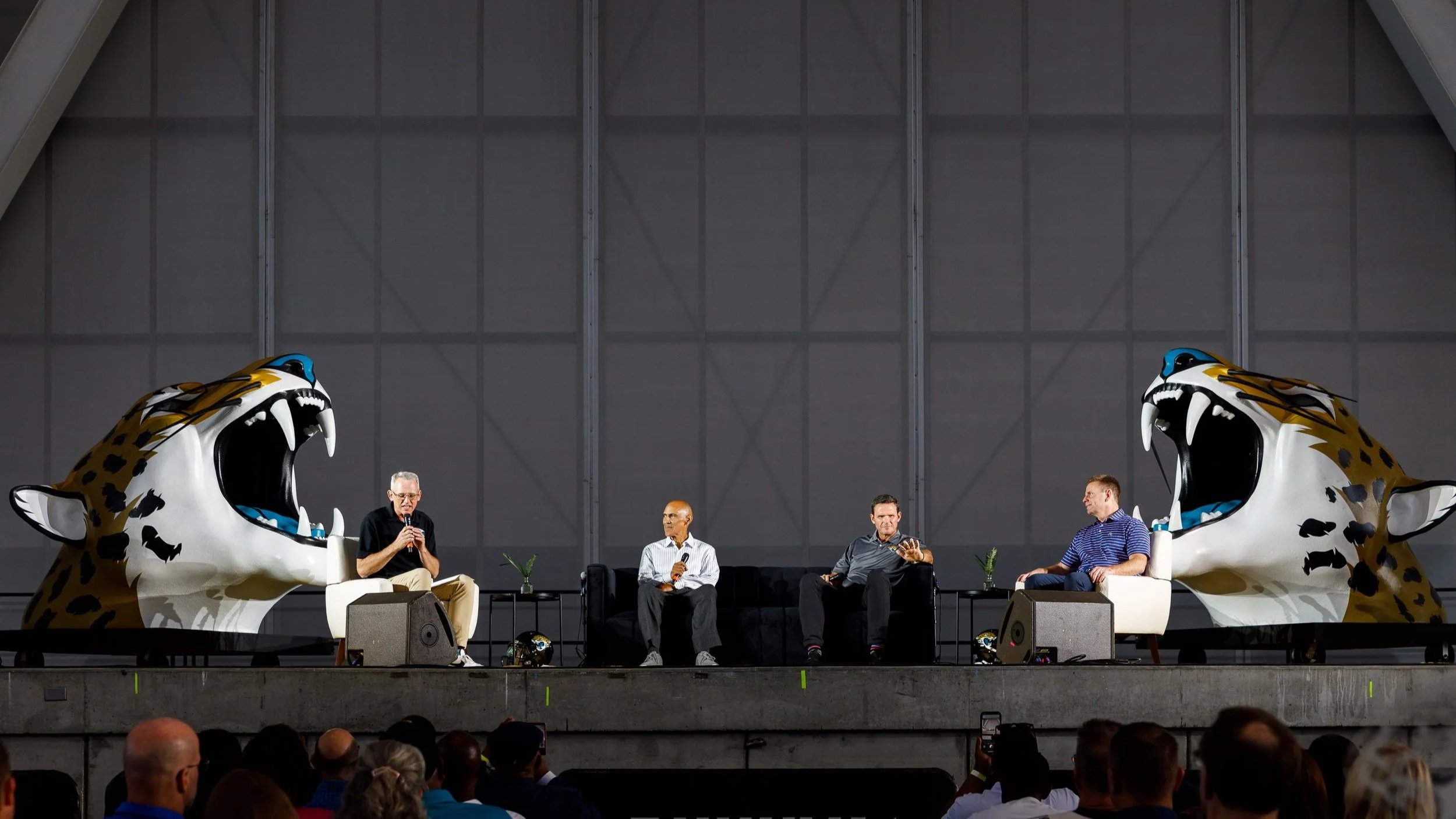 Panel discussion on stage featuring Pastor David Tarkington, Hall of Fame Football coach Tony Dungy, Hall of Fame Jaguar Tony Boselli, and Jaguars voice Brian Sexton.