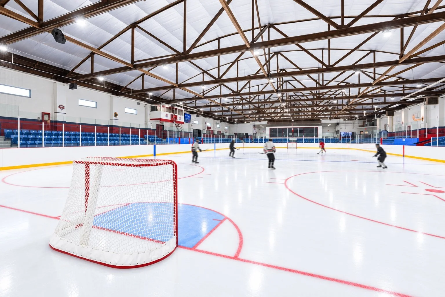 Hockey players on the ice at Ted Reeve Arena, a CHERIE NG ARCHITECT INC. (CNA) project.