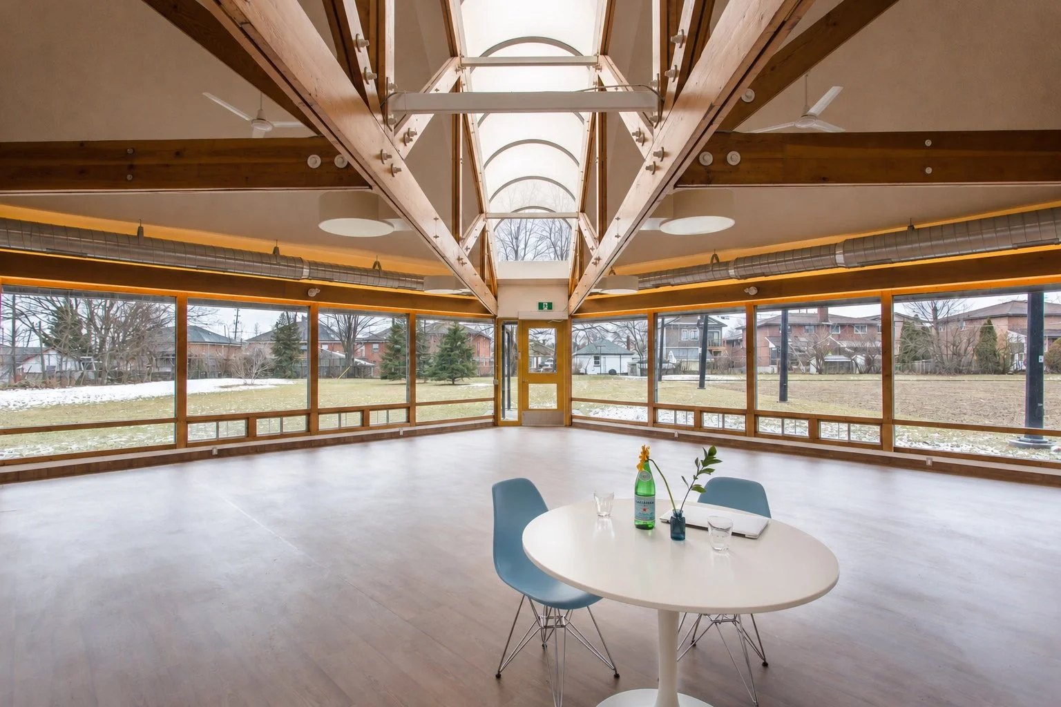 Coronation interior with exposed timber beams, skylights and windows overlooking the grounds, a CHERIE NG ARCHITECT INC. (CNA) project.