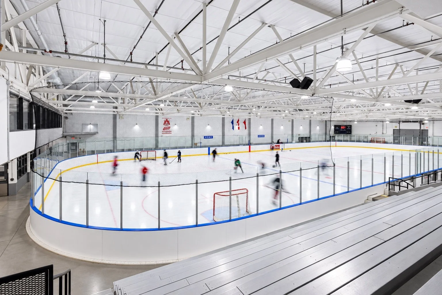 Indoor ice rink and spectator seating at a Mississauga arena, a CHERIE NG ARCHITECT INC. (CNA) project.