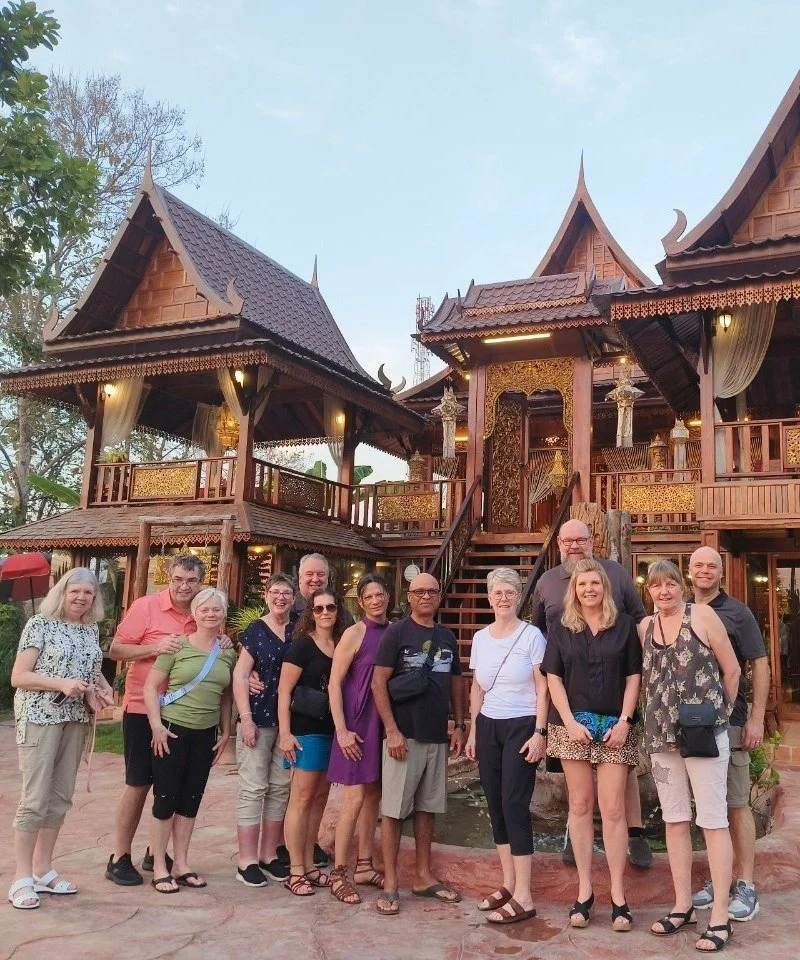 Karen's group in front of a traditional Thai teak house