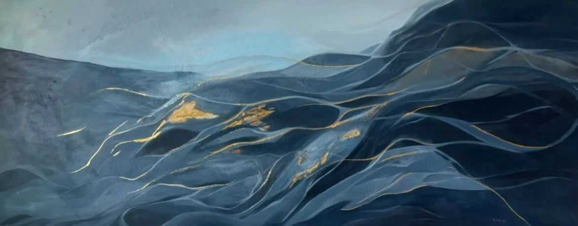 Close-up of ocean waves with dark blue and gold highlights.