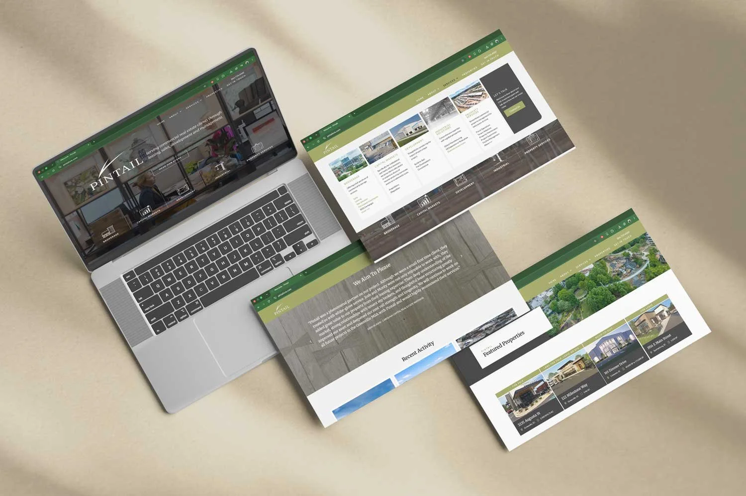 Laptop and printed website mockups displaying a real estate website with property listings, services, and featured homes
