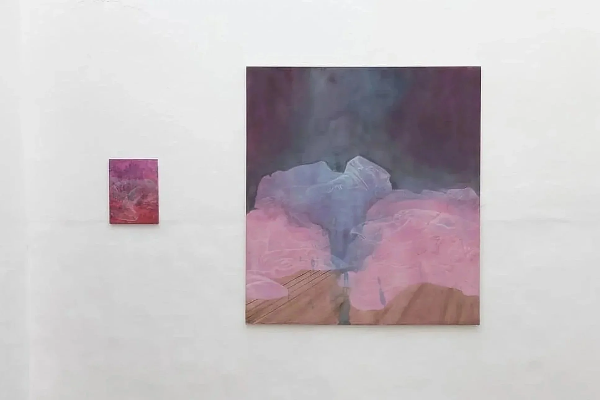Installation view of two paintings by Luca Japkinas in Déjà Vu (2024) at Dialogue Gallery, Lisbon, featuring a large composition in pink, purple and muted blue alongside a smaller painting in similar tones.