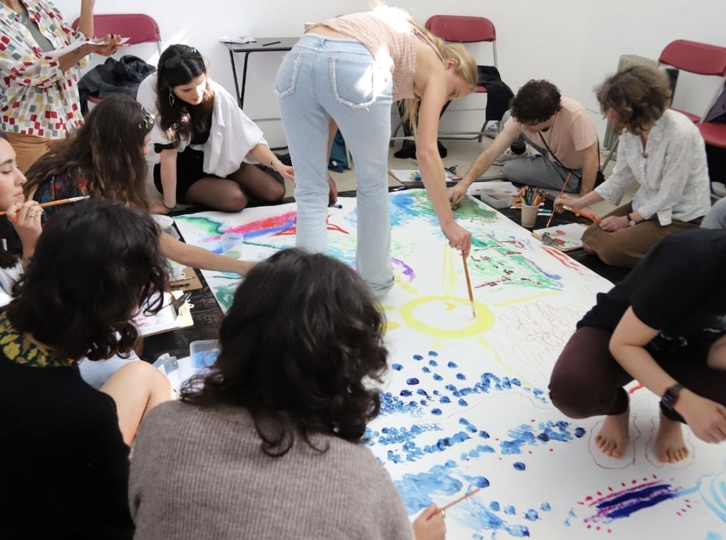 Participants creating a collaborative mural during Alice May's workshop for To Be Here With You at Southwark Park Galleries, London, exploring their creative connection to the park and one another.