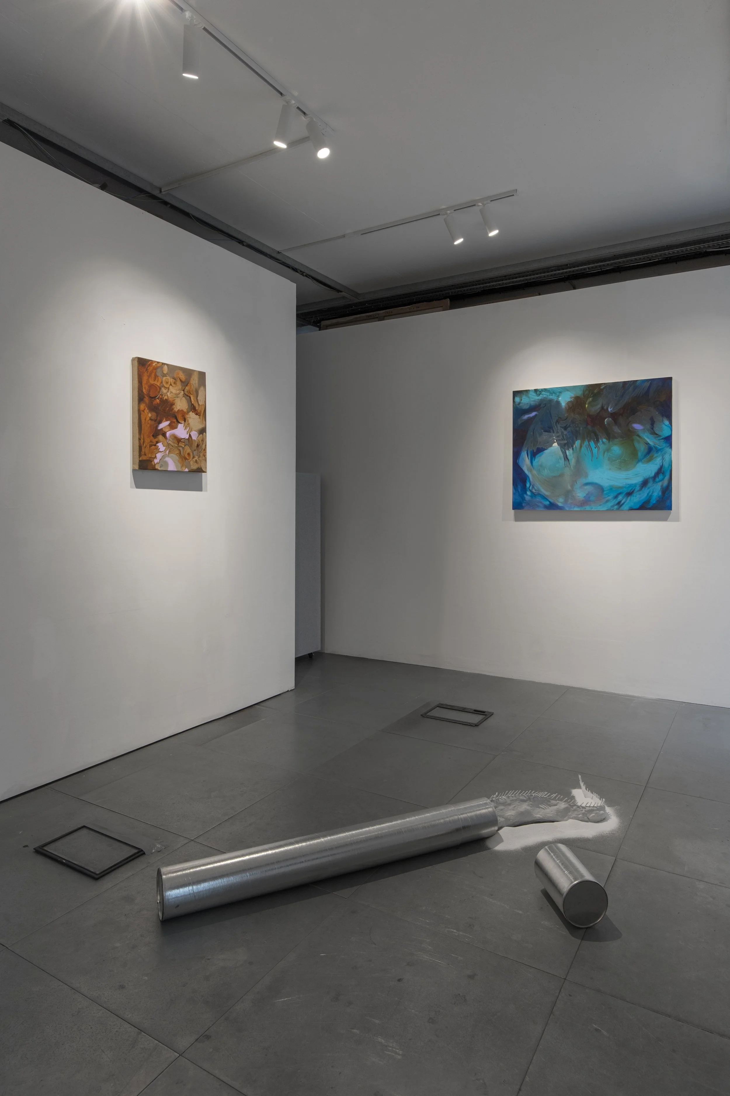 Installation view of Commencement / Commandment (2026) at Prokofiev Studio, London, featuring Anastasia Belinskaya's No Place To Hide (2026), a sculpture made from a reclaimed ice-core storage container, clay and silica sand, alongside Kika Sroka-Mil