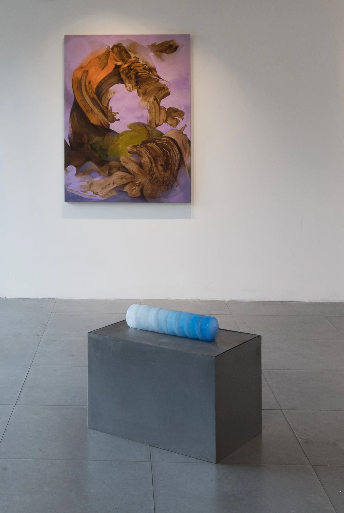 Installation view of Commencement / Commandment (2026) at Prokofiev Studio, London, featuring Kika Sroka-Miller's painting Not drawn from nature (2026), with its abstract orange, brown and violet forms, above Anastasia Belinskaya's Slowest Wave (2026