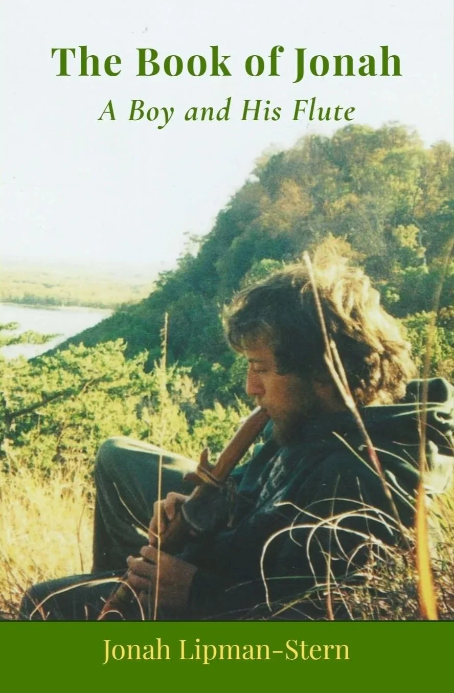 Book cover titled 'The Book of Jonah: A Boy and His Flute' by Jonah Lipman-Stern, depicting a young man playing a flute outdoors in a green, hilly landscape with trees and a river in the background.