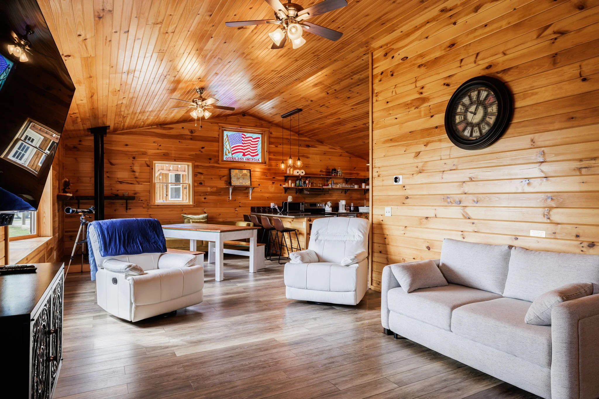 Cozy wood-paneled living and dining area at Bella Vista Retreat with comfortable seating and dining table.