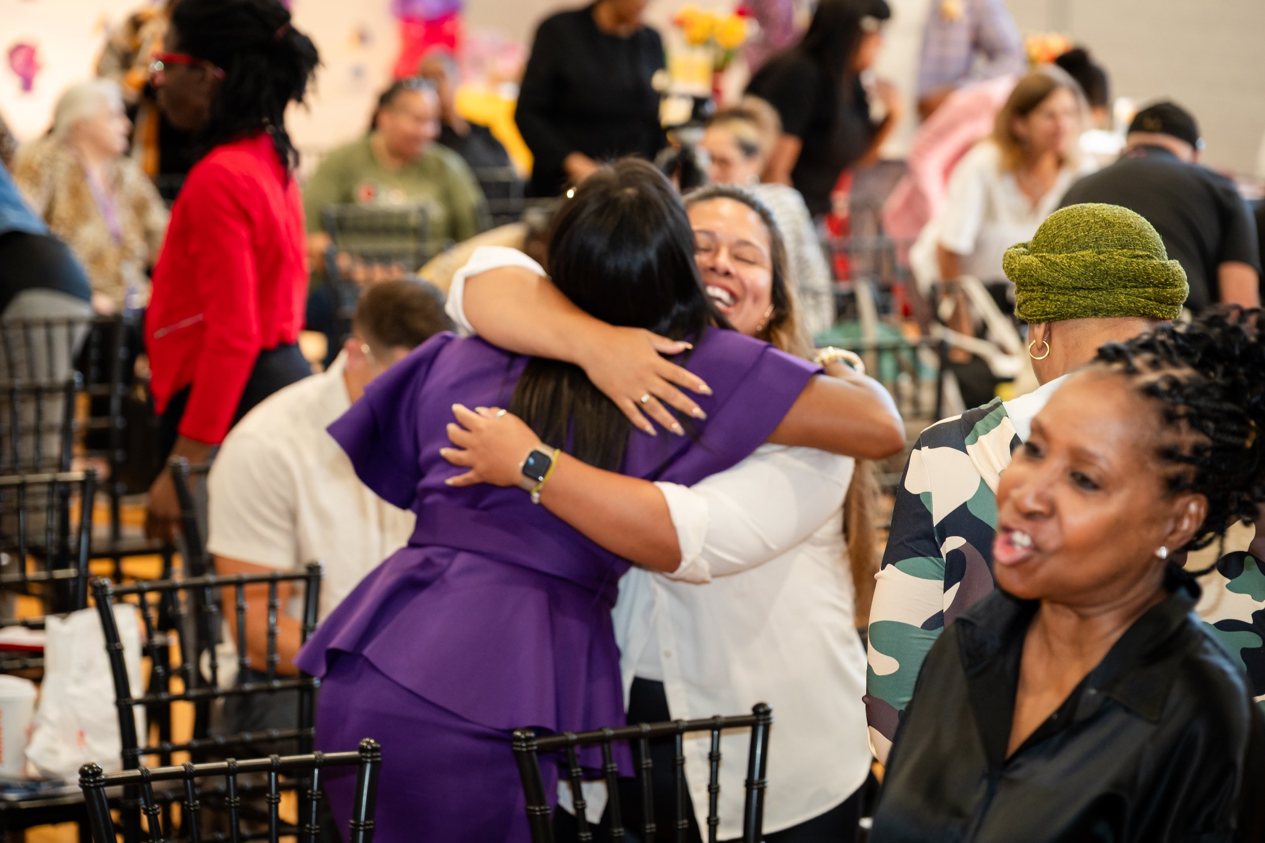 Women embracing at the Blossoming Beyond Bars Women's Reentry Wellness Conference