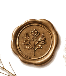 Close-up of a gold-colored wax seal with a tree emblem embossed on it.