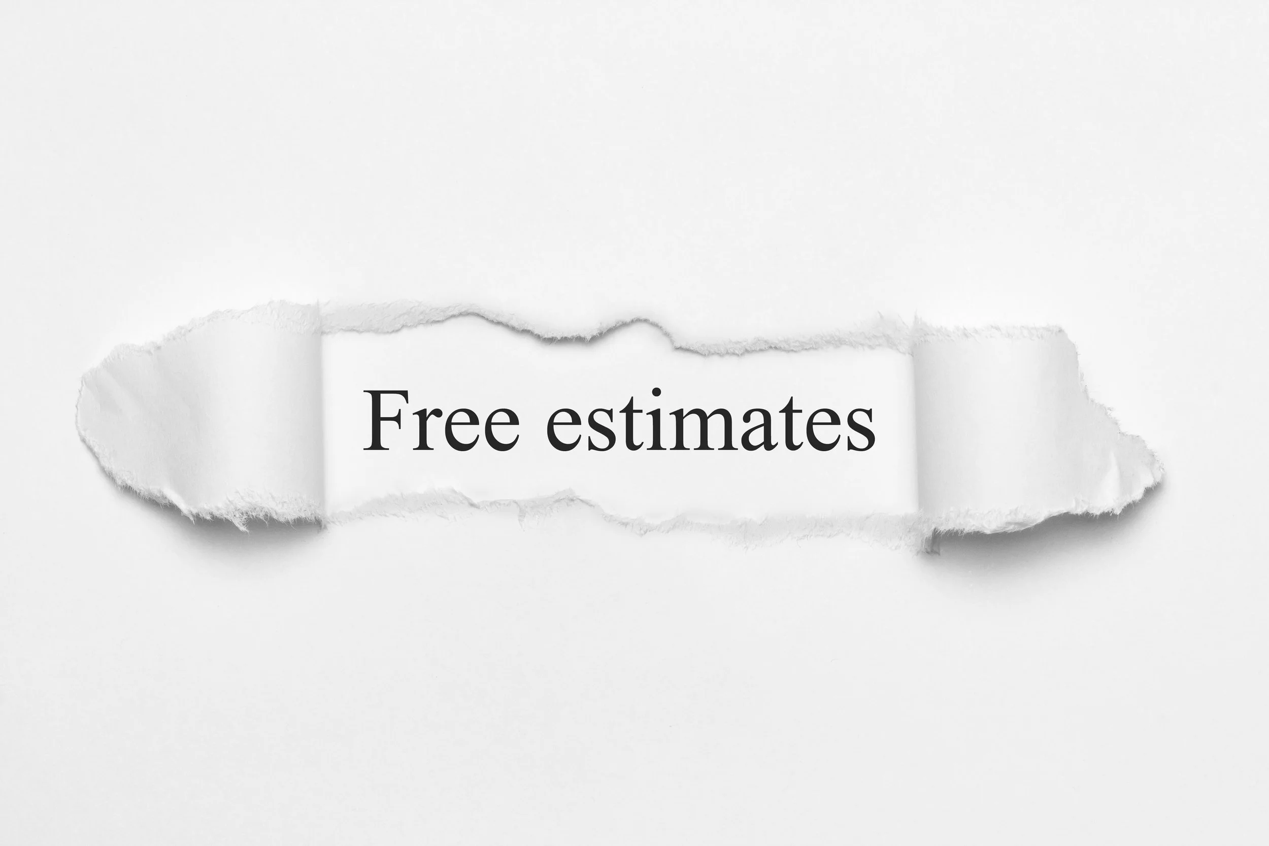 A torn piece of white paper with the words "Free estimates" printed on it, against a plain white background.