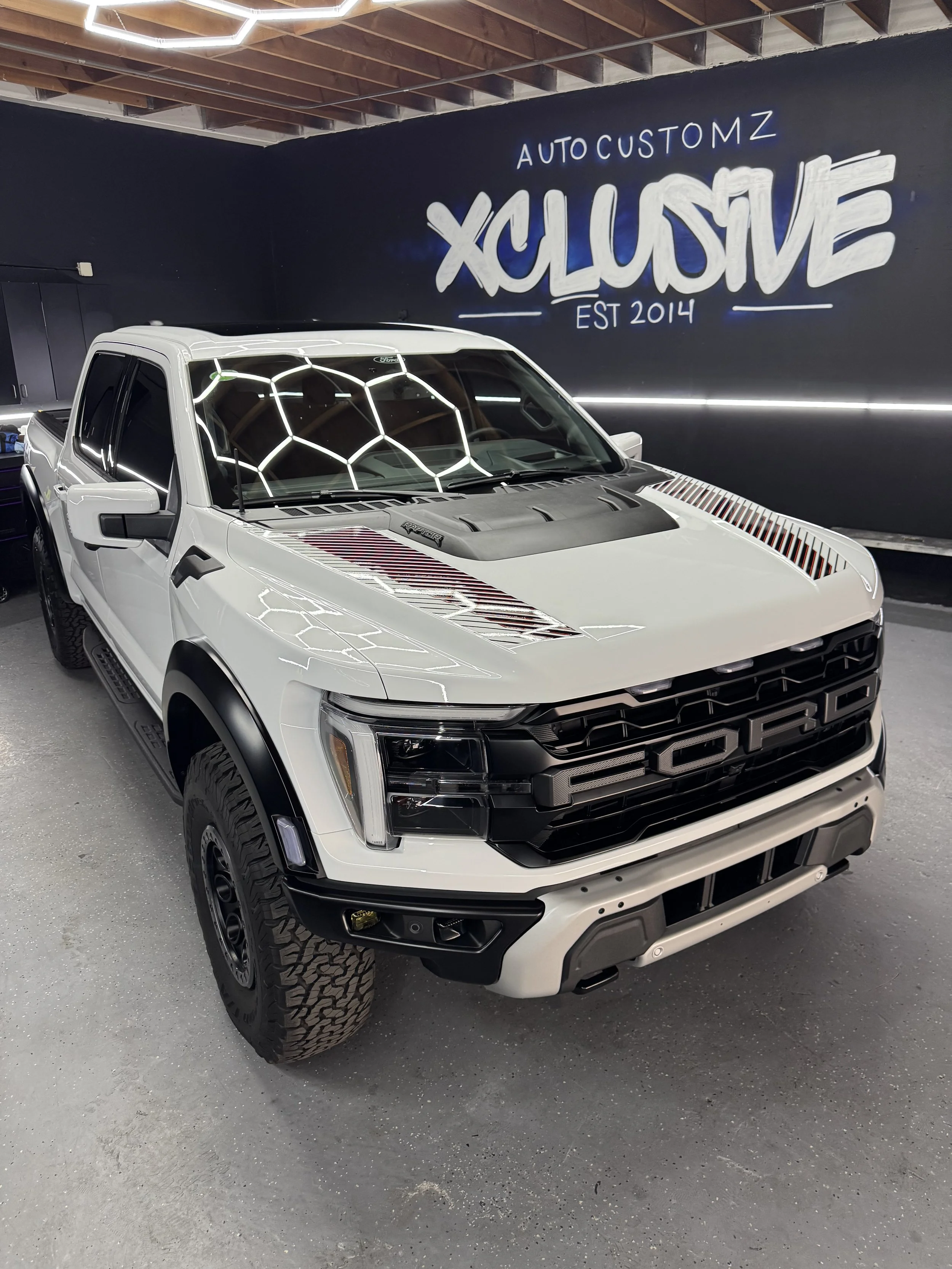 White Ford pickup truck with custom honeycomb hood wrap at Xclusive Auto Customz in Santee, CA