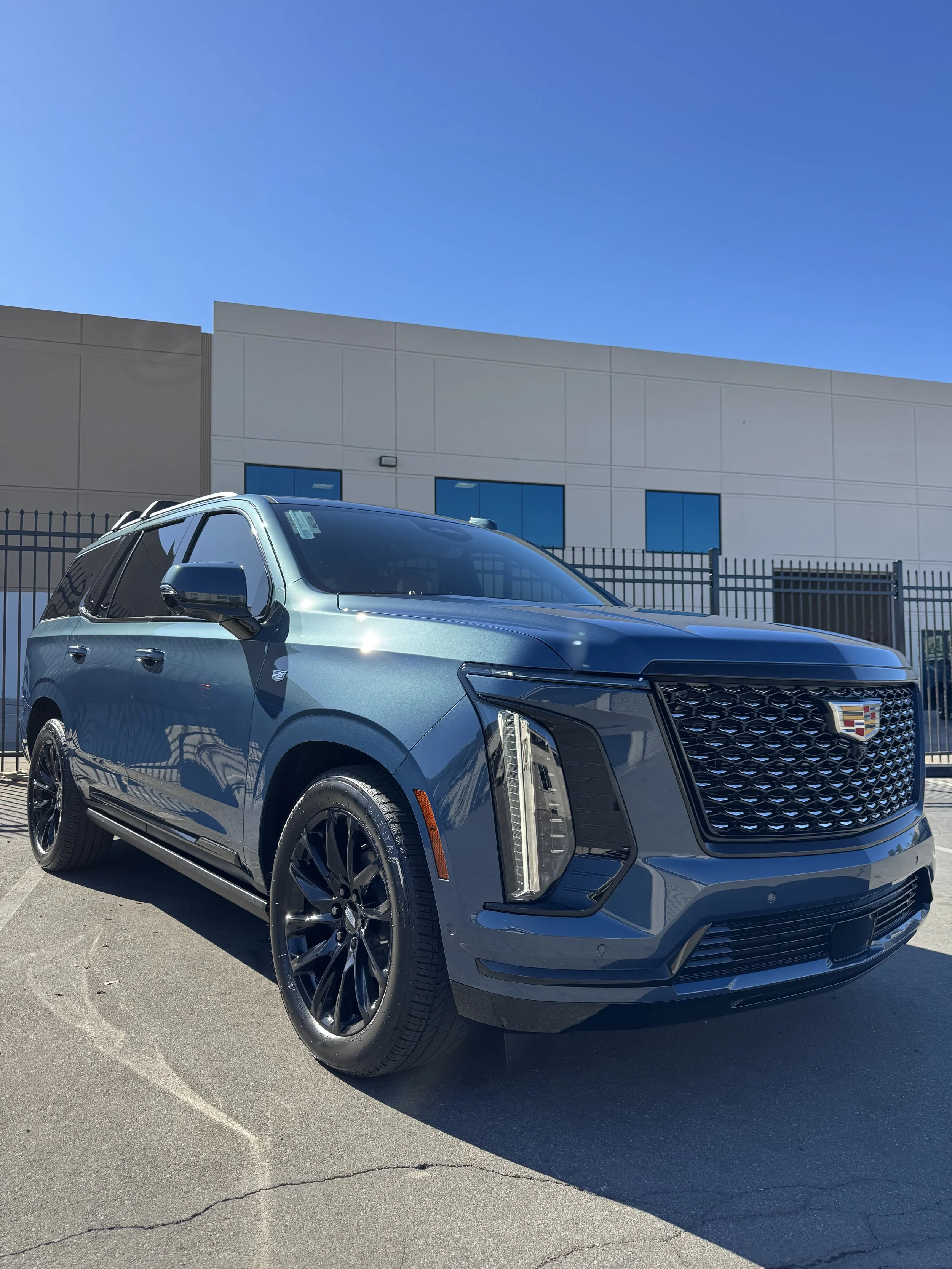 Blue Cadillac Escalade with paint protection film parked at Xclusive Auto Customz in Santee, CA