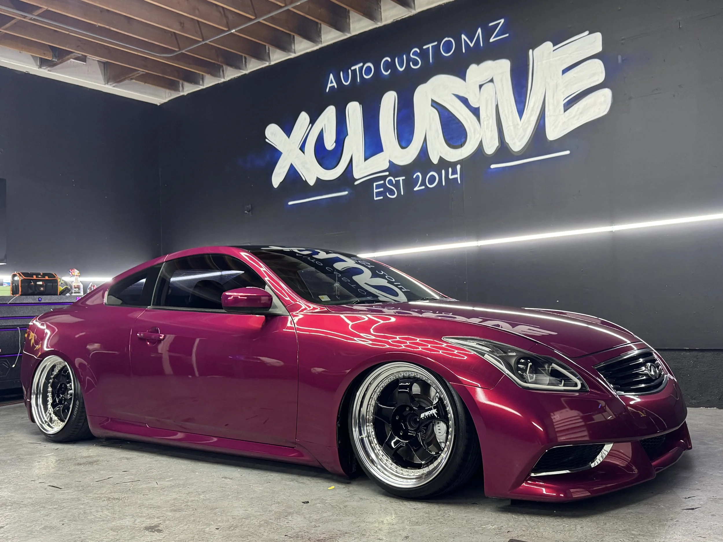 Magenta Infiniti G37 coupe with custom wrap and chrome wheels at Xclusive Auto Customz in Santee, CA