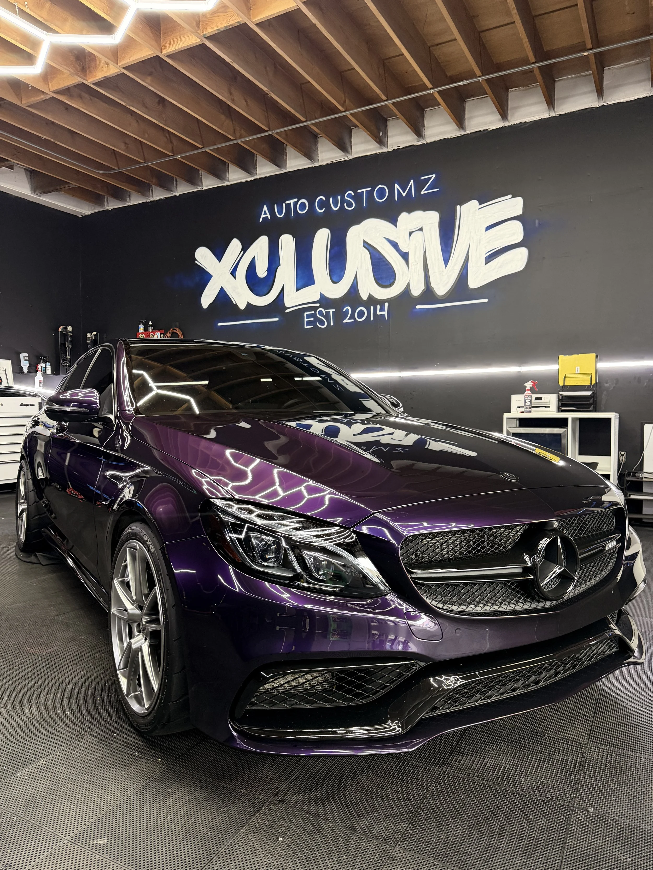 Purple Mercedes-Benz sedan with lightning-design paint protection film at Xclusive Auto Customz in Santee, CA