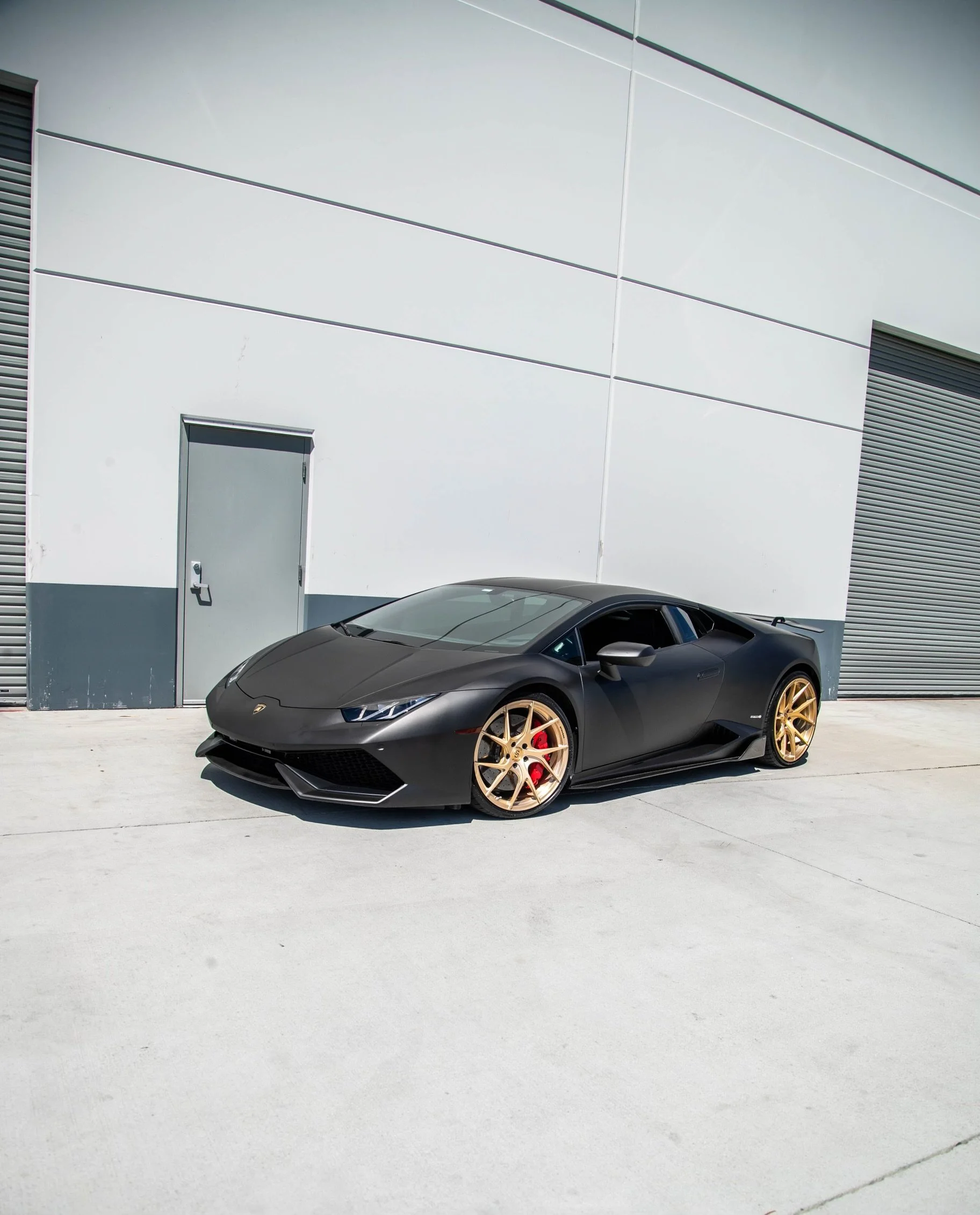 Matte black Lamborghini Huracan with gold wheels at Xclusive Auto Customz in Santee, CA