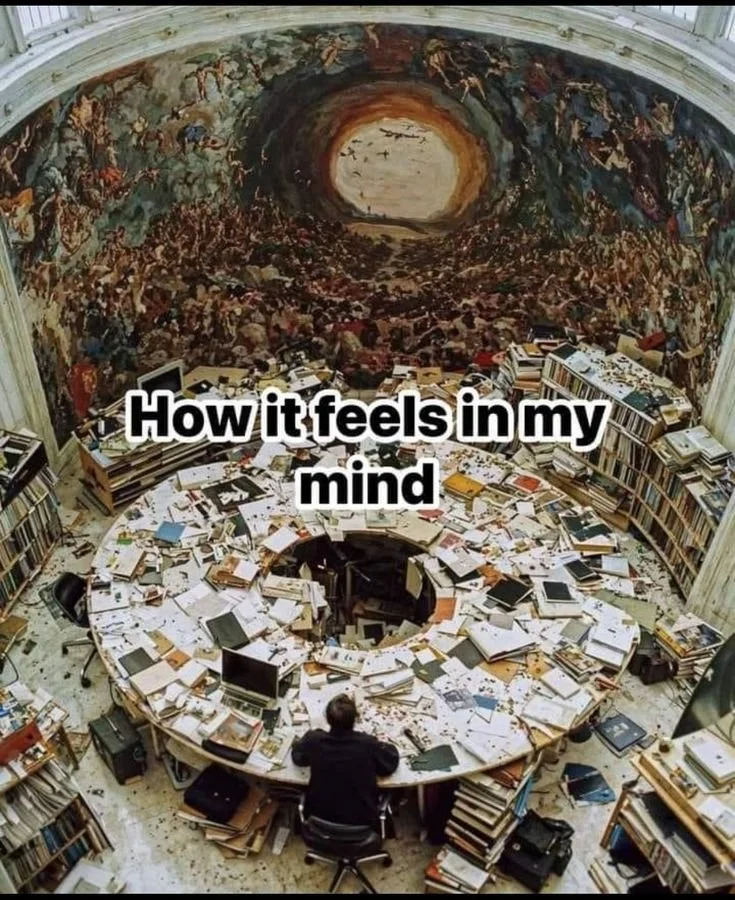 ADHD meme of a man sitting at a large circular desk with papers, notebooks, computers, and book cases encompassing every square inch of the desk and the room