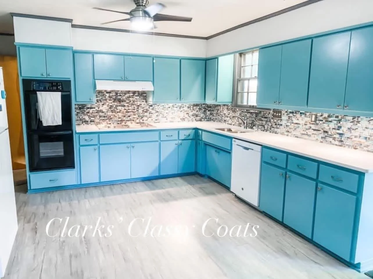 Kitchen cabinets painted turquoise with white countertops