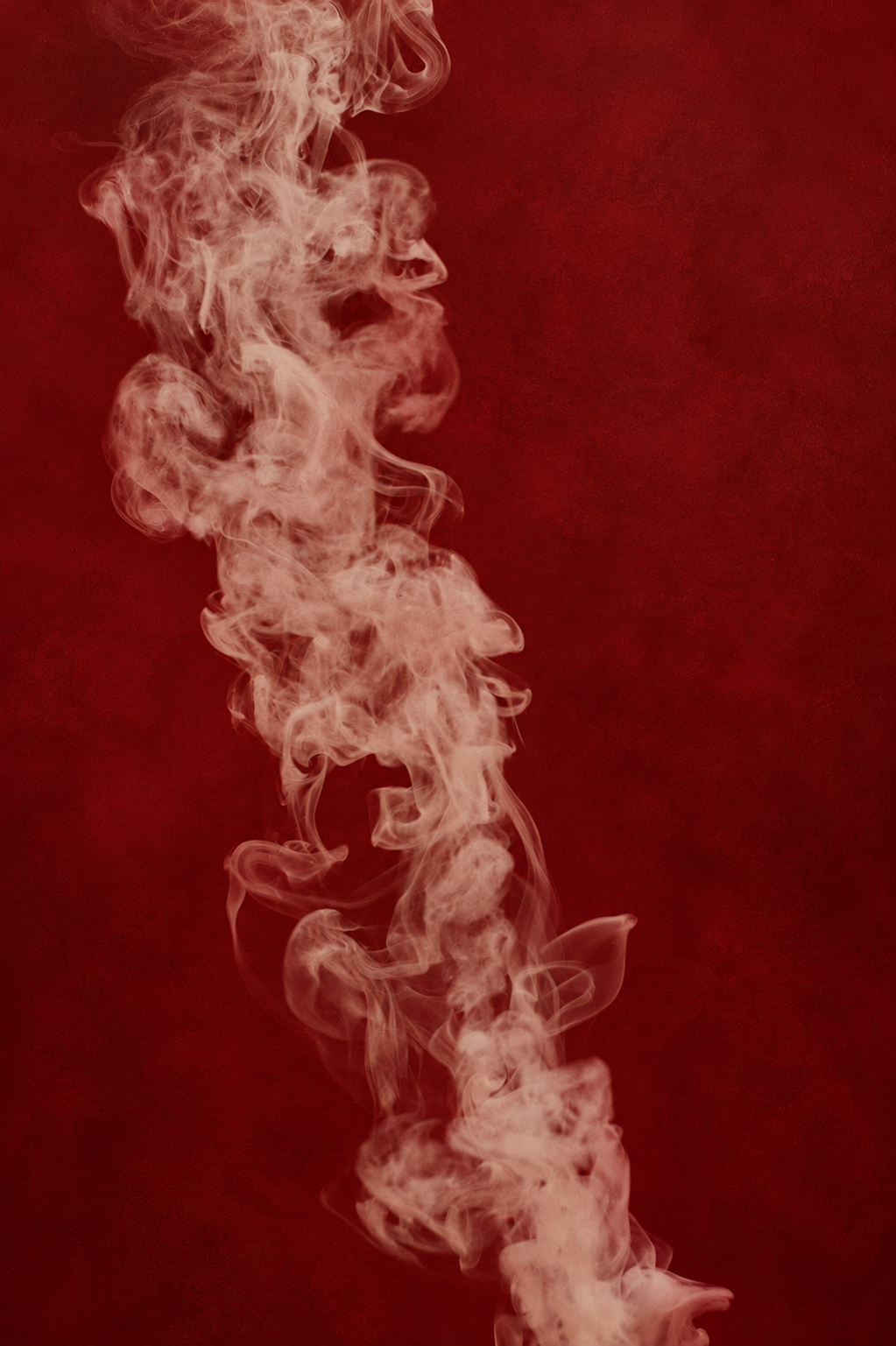 Pink-colored smoke rising against a dark red background.