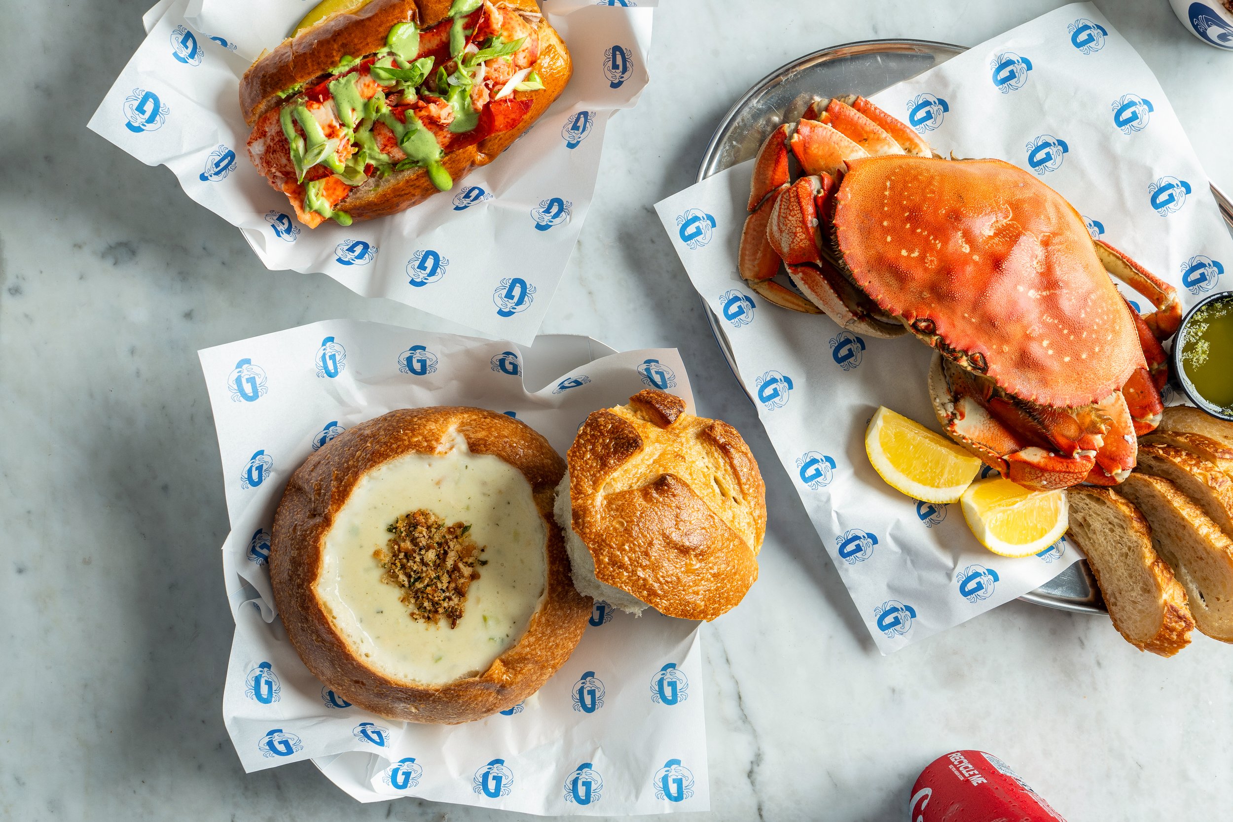 Seafood spread with chowder, lobster roll, and Dungeness crab