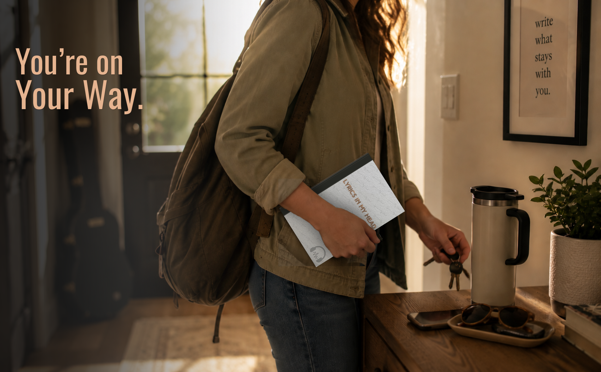 A woman with curly hair holding a book titled "Lyrics in My Head" as she opens a door with keys in her hand in a cozy kitchen with warm sunlight, a plant, a coffee kettle, sunglasses, and framed wall art.