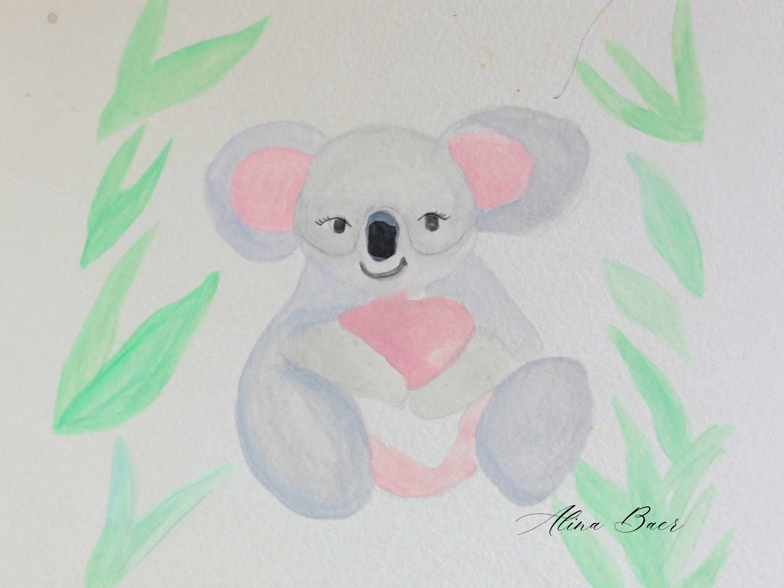 Watercolor illustration of a koala bear with pink cheeks and a smiling face, surrounded by green leaves, with the artist's signature 'Alina Baer' in the corner.
