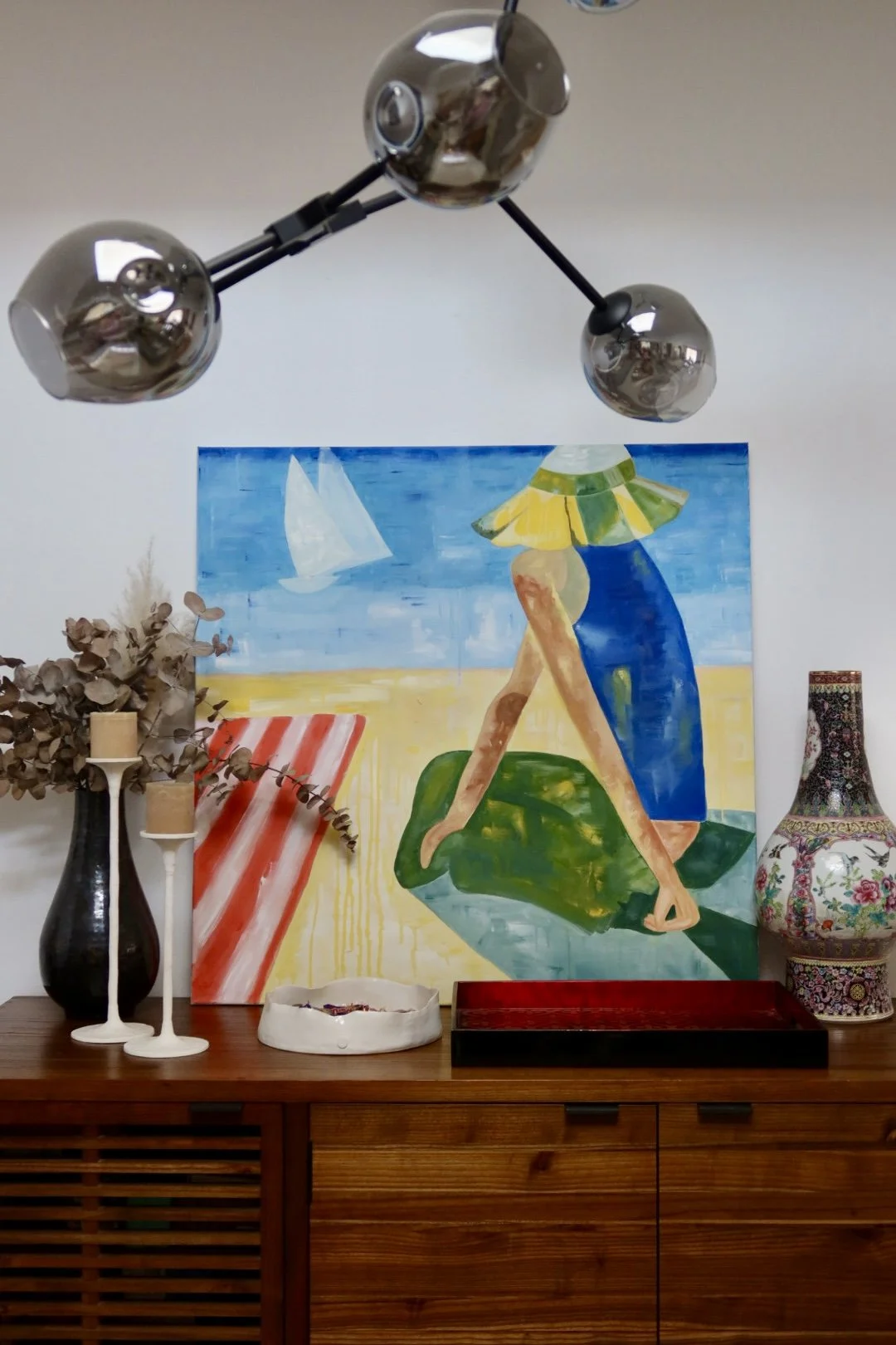 Interior decor with a colorful painting of a woman at the beach under the sun. 