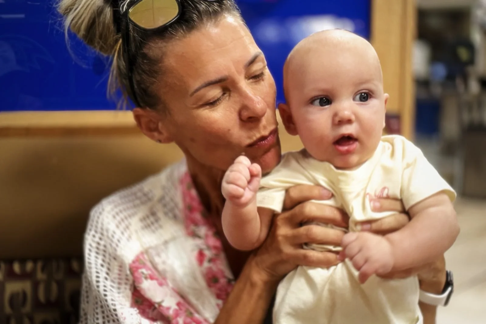 Gigi kissing baby Koby's little fist