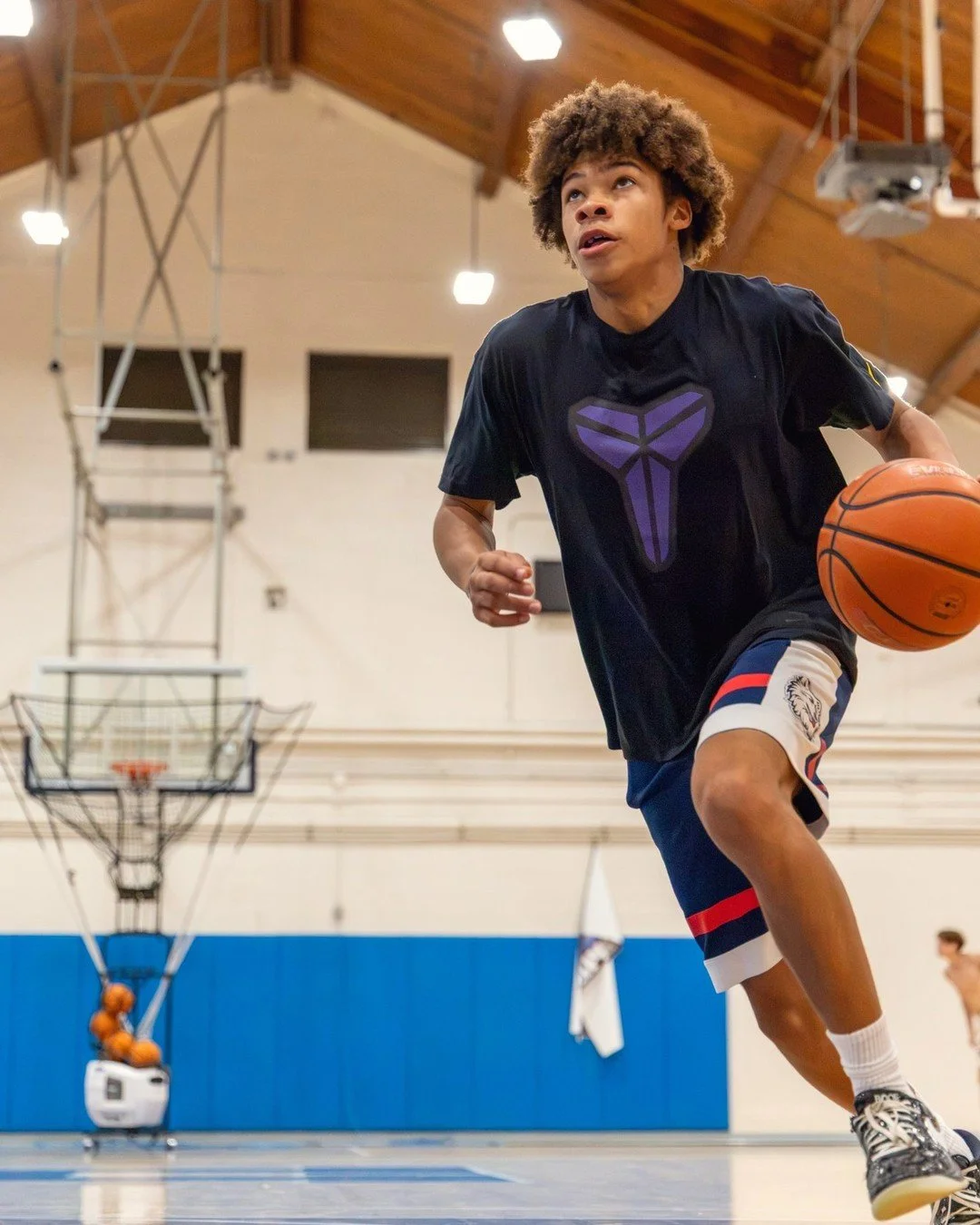 Basketball player driving to the hoop during a high school game